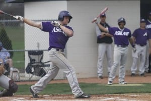 Young Ashland baseball player hitting ball with a man on deck in purple uniforms