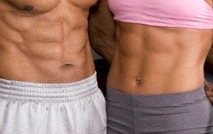 Couple with six packs in white shorts and gray pants and pink bra