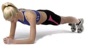 Young, blonde woman wearing purple and black doing high plank