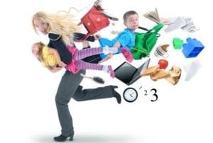 Young blonde woman in gray and black carrying little girl running away from lots of stuff flying behind her