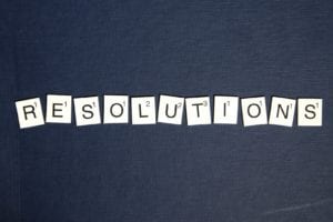 Resolutions spelled in scrabble tiles on black background