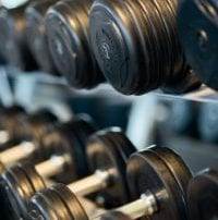 Two racks of black and silver dumbbells