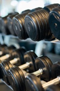 Two racks of black and silver dumbbells