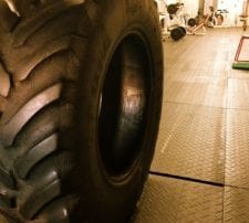 close up of large tire on gym metal floor