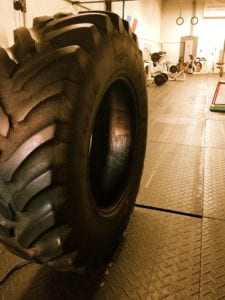 close up of large tire on gym metal floor