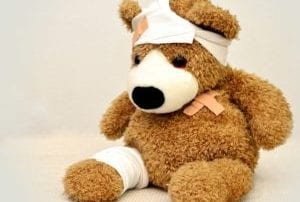 Brown furry teddy bear wrapped in bandages
