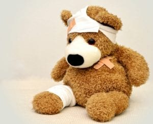Brown furry teddy bear wrapped in bandages