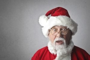 Headshot of santa looking surprised with gray background