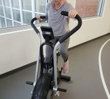 Young woman working out on exercise bike