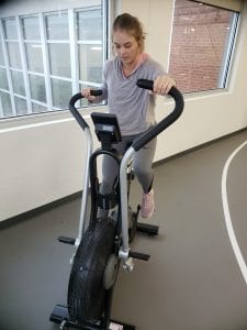 Young woman working out on exercise bike