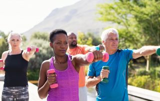Mature fitness people exercising with dumbbells