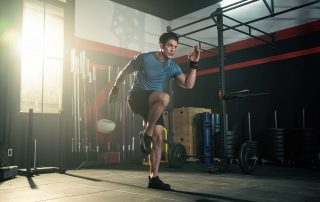 Man in exercise facility taking cardio steps.