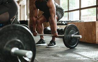 Man lifting barbell at gym